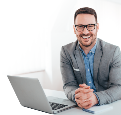 Photo: Happy business executive at laptop ready for AI Leadership training.