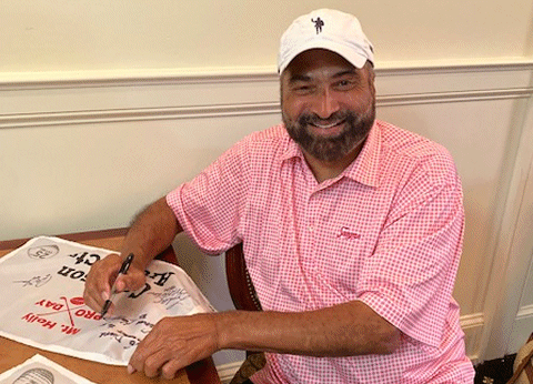 Franco Harris autographing Pro Day sponsor flags